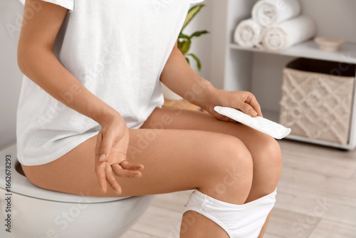 Young woman with menstrual ...