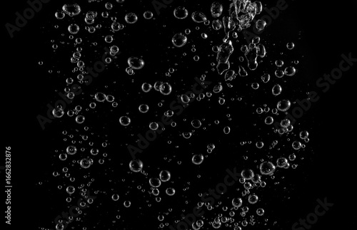 Clear water bubbles rising in dark background, abstract underwater texture ideal for design, science, and creative projects. Perfect for backgrounds, overlay, or refreshing clean concept visuals.