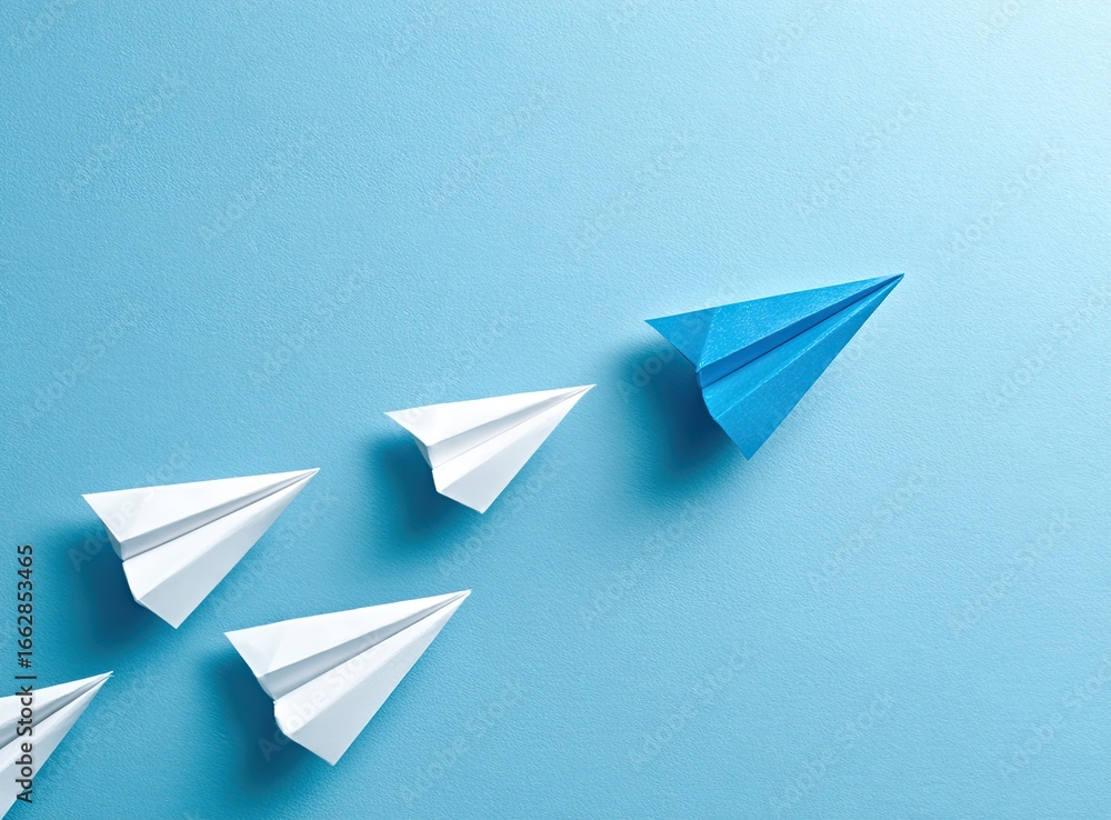 Naklejka premium Leading paper planes on light blue