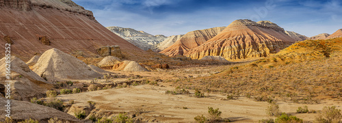 Panoramic view of colorful mountains and desert shrubs in Altyn Emel National Park, Kazakhstan, showcasing the beauty of nature