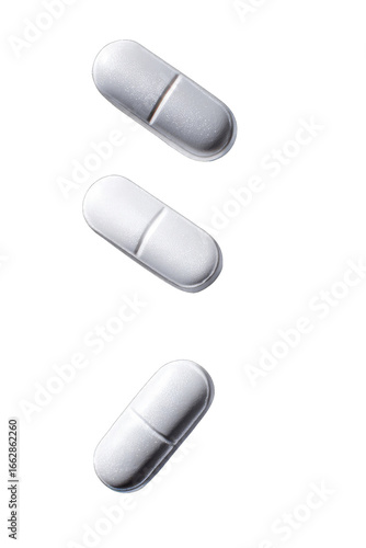 Three white pills in a vertical arrangement