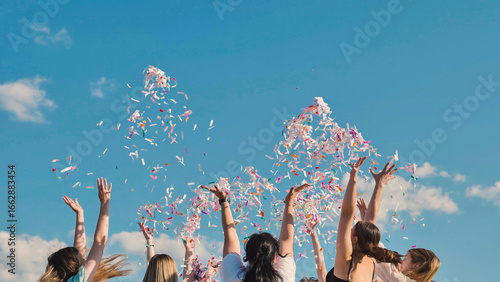 Schilderij op canvas Students celebrating their graduation by tossing colorful confetti into the summ