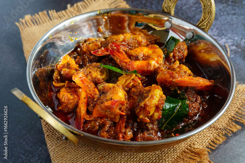 Authentic Kerala style prawn ghee roast, spicy South Indian seafood delicacy made with fresh prawns, clarified butter, roasted spices and curry leaves, traditional Malabar coastal dish