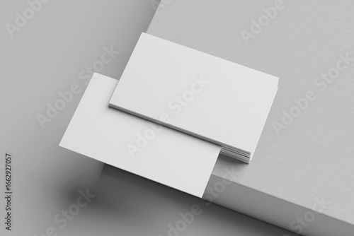 White business card stack on a concrete desk 3D rendering