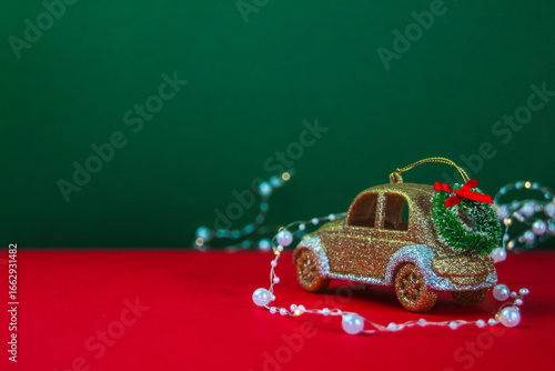 A golden car with a Christmas wreath on the roof, surrounded by white beads