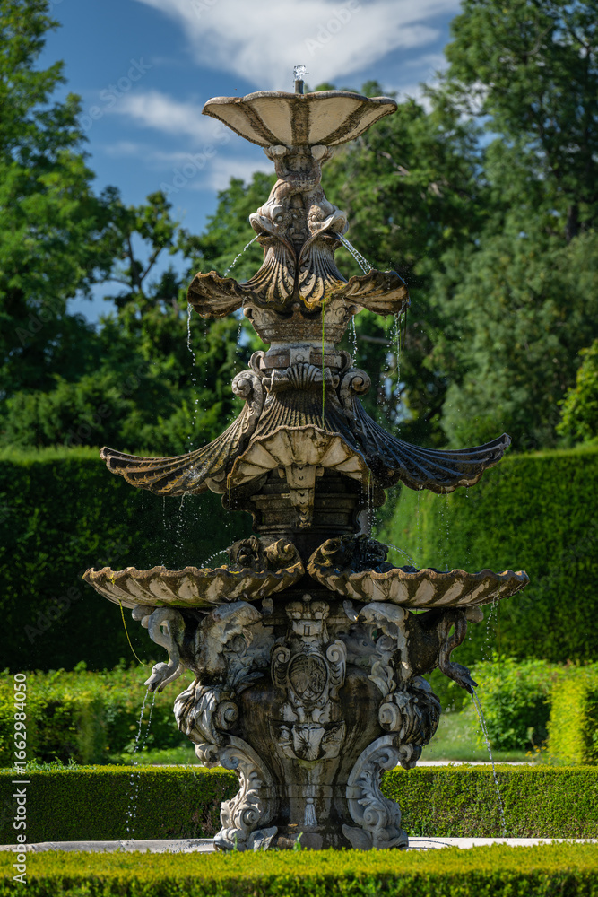 Obraz premium A large and old castle fountain outdoors in the park.