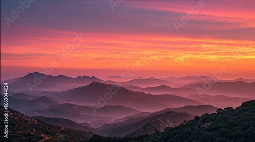 Mountain range at sunrise, hazy, colorful sky
