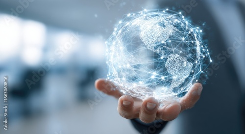 Person holding a glowing digital globe, representing global network connectivity