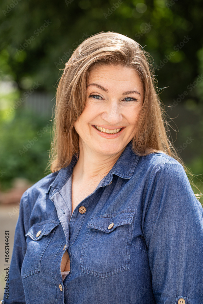 Portrait of a beautiful middle-aged woman in a summer park Portrait of a beautiful middle-aged woman in a summer park