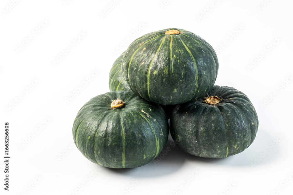 Whole green-skinned pumpkin on white background, autumn harvest Whole green-skinned pumpkin on white background, autumn harvest