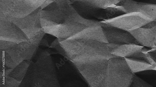 Dark wrinkled paper texture with aged grunge surface. Perfect for use as background, distressed overlay, retro wallpaper, or abstract design element in creative projects.
