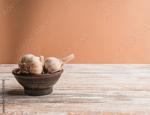 Garlic bulbs on a wooden table with copy space.