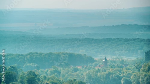 Green landscape with church in Lorry Mardigny village, France. Time lapse