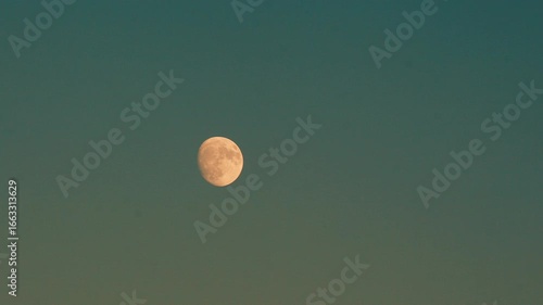 Moon in the sky shining during daylight.