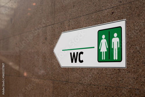 Sign indicating men and women restrooms. WC with clear direction and symbols. Ideal for public spaces, office buildings, airports, malls and facilities requiring restroom signage