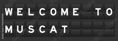 Black color analog flip board with word welcome to muscat on gray background