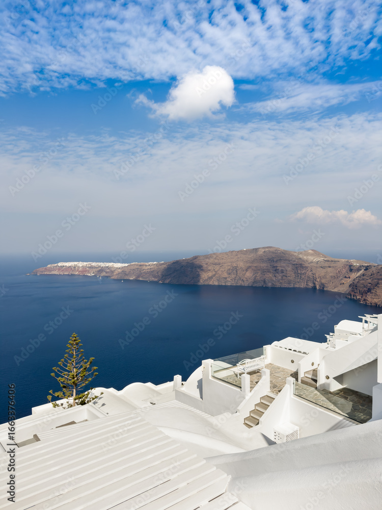 Fototapeta premium White architecture in Santorini island, Greece. Blue sky with white clouds at sunny day.
