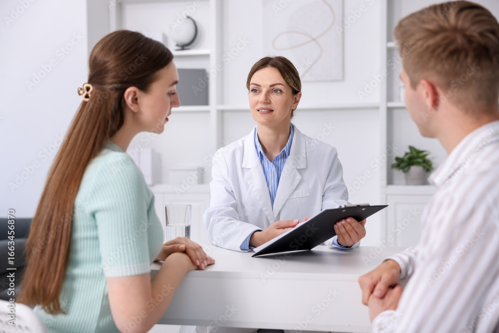 Fototapeta premium In vitro fertilization (IVF). Couple having appointment with doctor in reproductive clinic