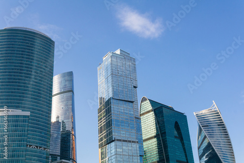 urban background, view of modern skyscrapers tops against blue sky