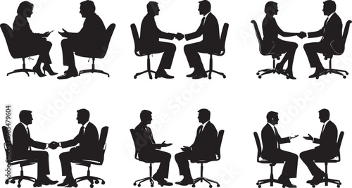 Two business people sitting, discussing terms or shaking hands over a deal.