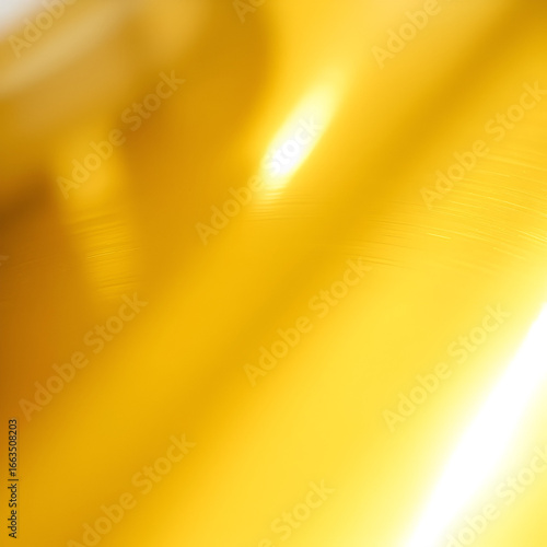 Close-up of a bright and reflective golden metallic surface