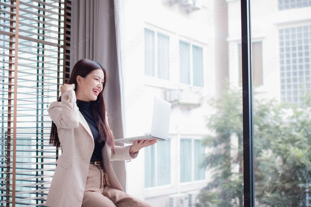 Fototapeta premium Smiling professional businesswoman in office, confident and ambitious, planning career goals, networking online, considering success, leadership, strategy, motivation, calm thinking.