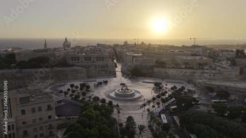 Cinematic HDR 4K drone footage of Valletta, Malta at sunrise - Aerial shot moving forward slowly towards the historic old city