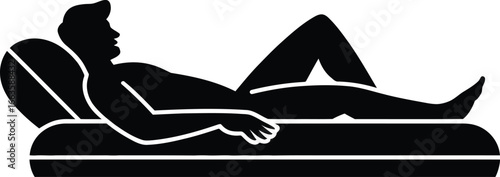 Silhouette of a man relaxing on an inflatable air mattress