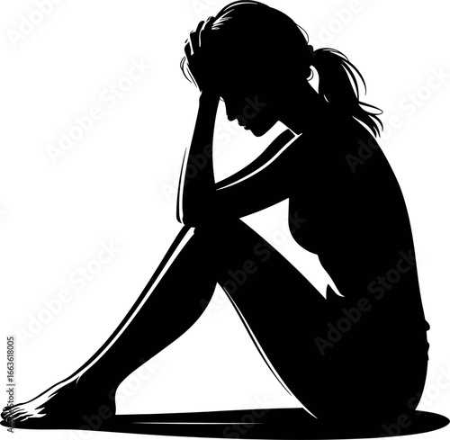 Silhouette of a woman in despair sitting down with her head in her hands illustrating mental health challenges and emotional stress