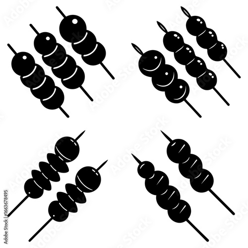 Four sets of black and white dango skewers arranged in a square pattern on a white background image
