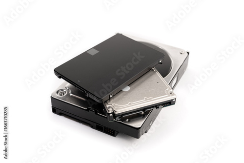 Pile of a variety of computer Hard disk drive HDD and SSD isolated on white background. Computer hardware data storage