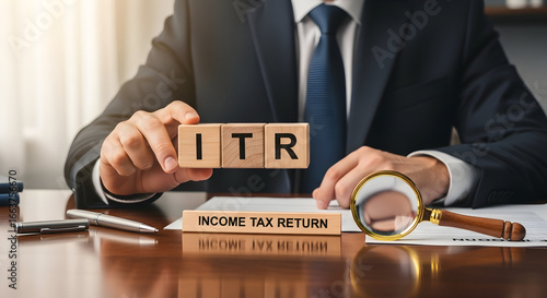 Professional holding wooden blocks spelling ITR on desk with income tax returns folder and coins — income tax filing, return submission and tax compliance concept