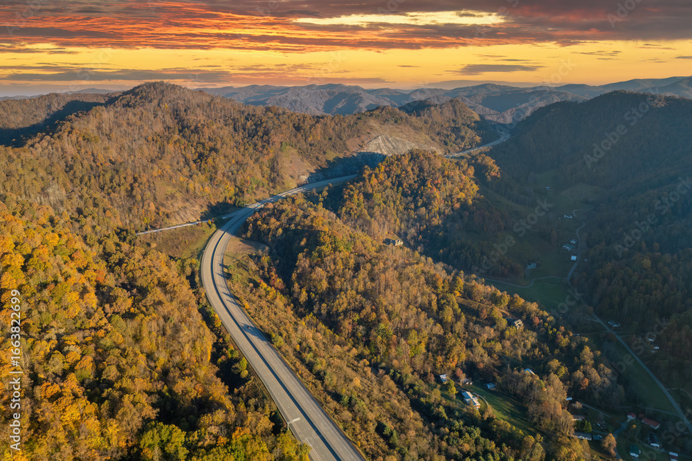 Naklejka premium Highway road in North Carolina Appalachian mountains in fall season. Expressway lanes for fast passing of car traffic