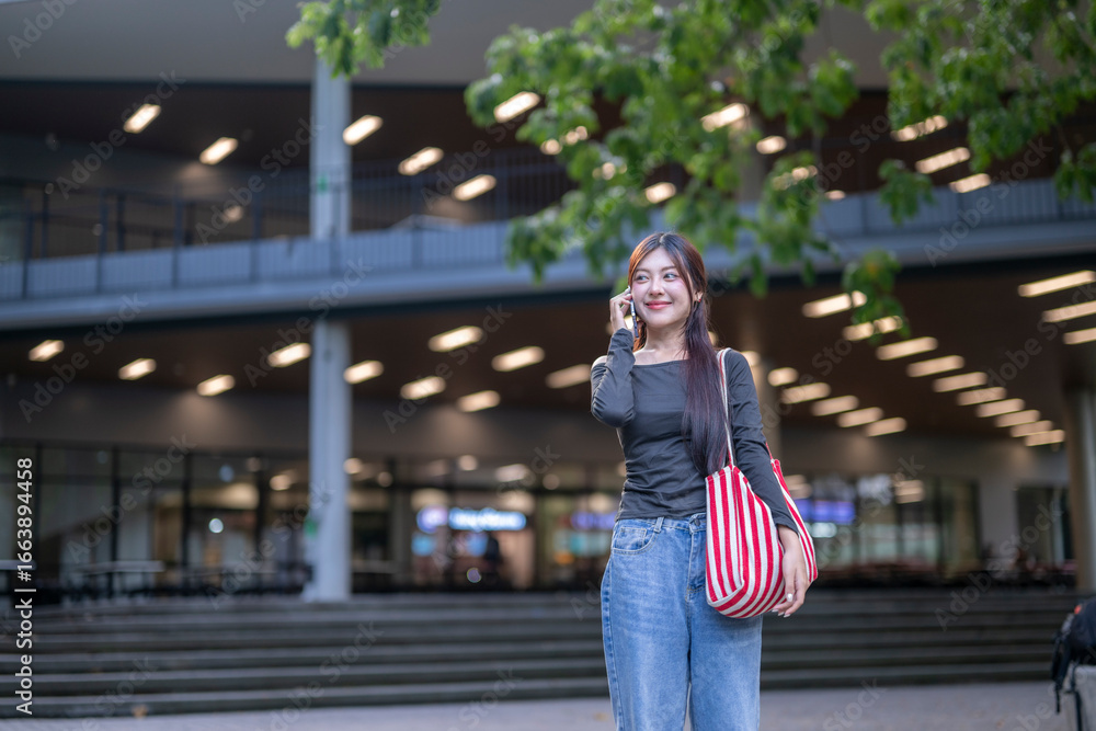 Fototapeta premium University student making a phone call on campus