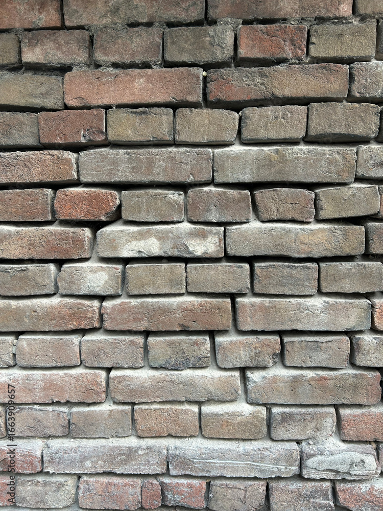 Fototapeta premium Old brick wall close up background in old Europe town