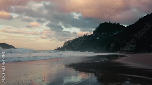 sunset over the sea on a remote beach in new zealand