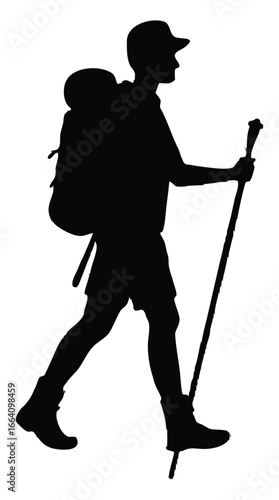 Silhouette of a hiker walking with backpack and trekking pole
