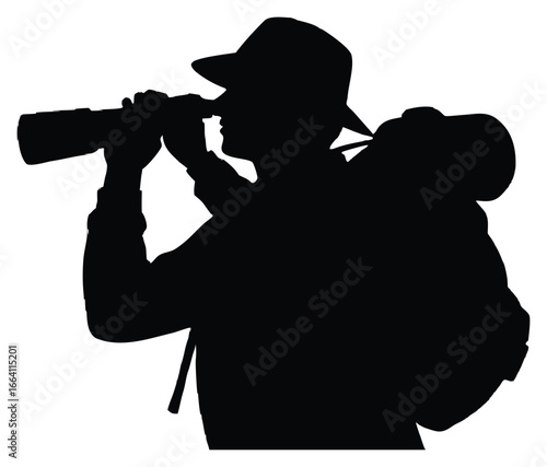 Silhouette of Wildlife Photographer with Backpack Looking Through Camera Lens in Nature