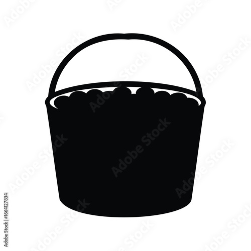 Silhouette image of a bucket with round objects possibly apples inside