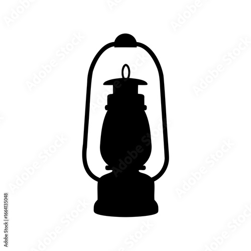 Silhouette of an old kerosene lantern casting an eerie glow in the night