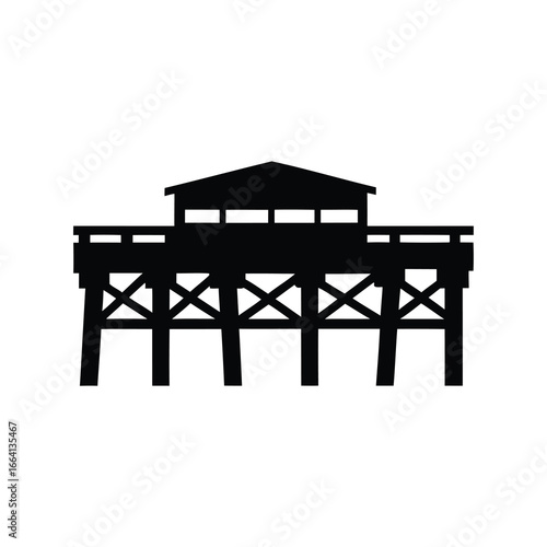 Black silhouette of a pier with a small building on top