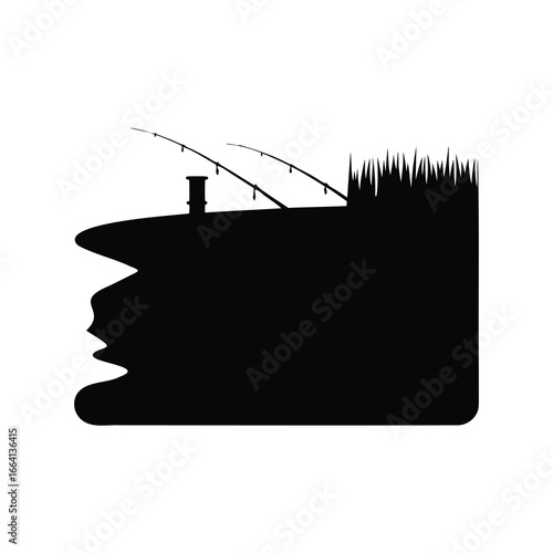 Silhouette of fishing rods and grass on the bank of a lake