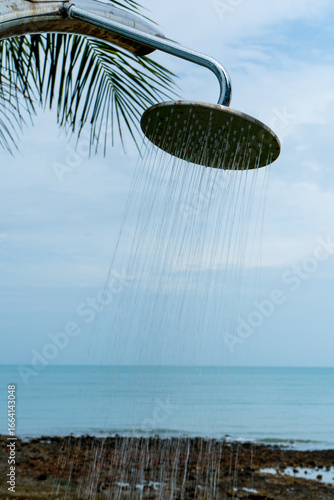 Tropical beach paradise outdoor shower with palm trees and sea views