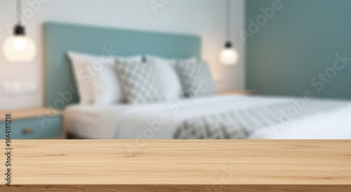 Wooden table in front of a blurred bedroom with teal headboard and pendant lights