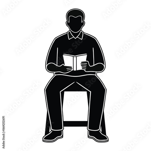 Silhouette of man absorbed in reading a book, enjoying quiet moment alone