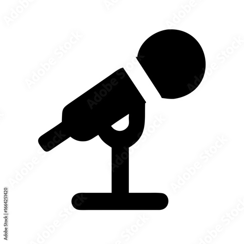 A simple black icon of a microphone on a stand, perfect for representing audio, broadcasting, and performance