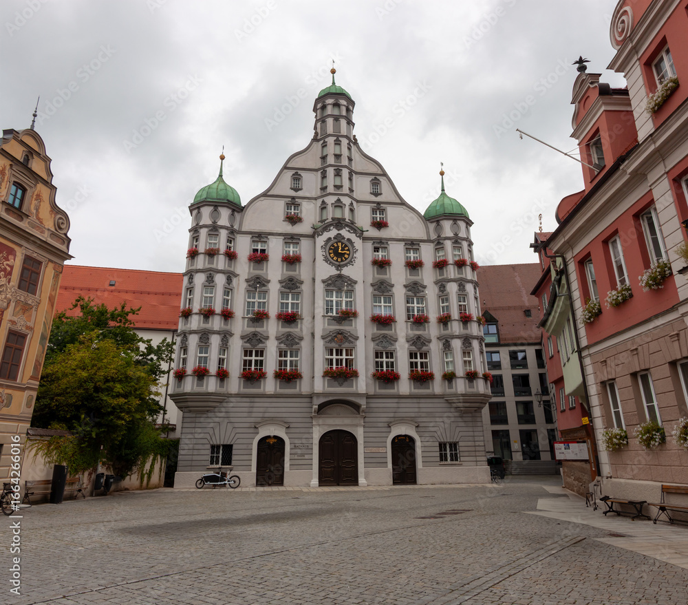 Obraz premium The historic Town Hall (Rathaus) of Memmingen, is a large, ornate building with a central tower and green domes