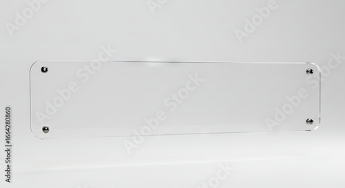 Rectangular clear acrylic sign with rounded corners mounted on wall with metal standoffs