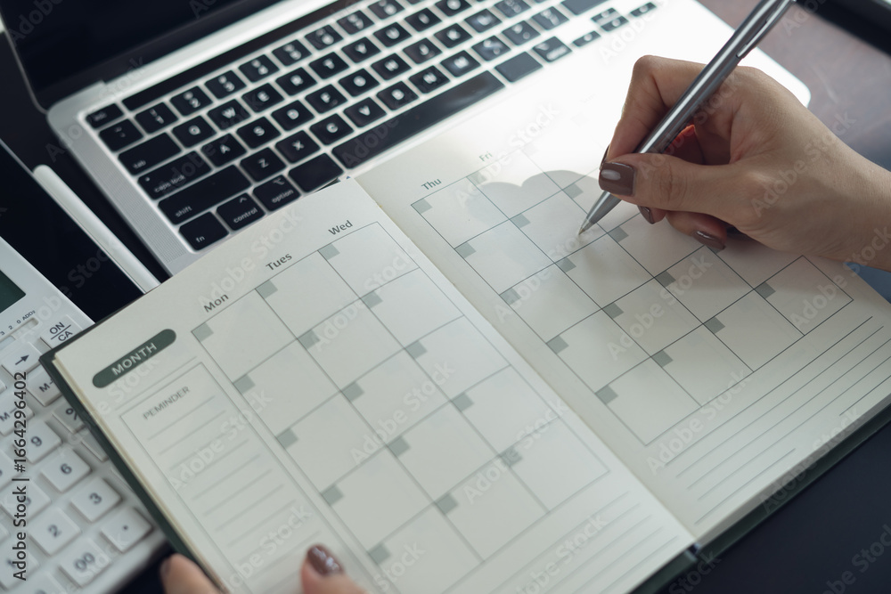 Φωτογραφία Closeup, woman hand writing on 2026 calendar event planner to set timetable organize schedule, event planning for business meeting or vacation plan