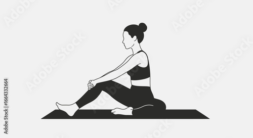 Woman in a seated yoga pose on a mat, side view.